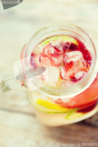 Image of close up of fruit water in glass bottle