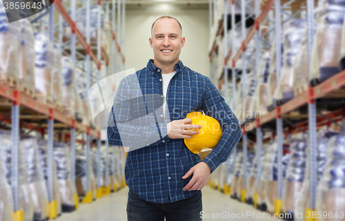 Image of happy man with hardhat over warehouse