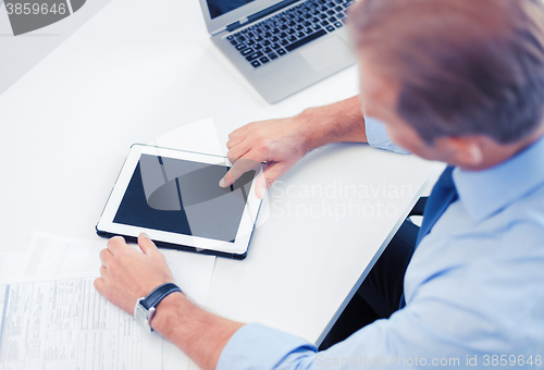 Image of businessman with tablet pc in office