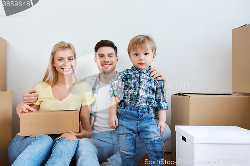 Image of happy family with boxes moving to new home