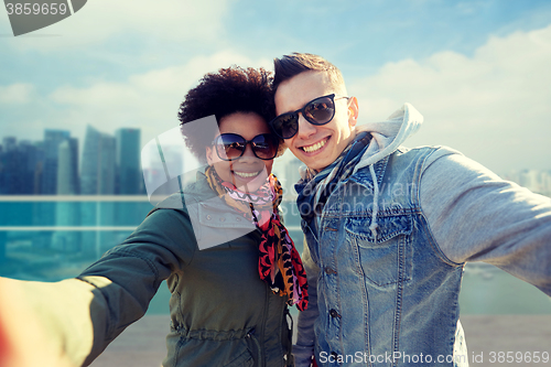 Image of happy teenage couple taking selfie in singapore