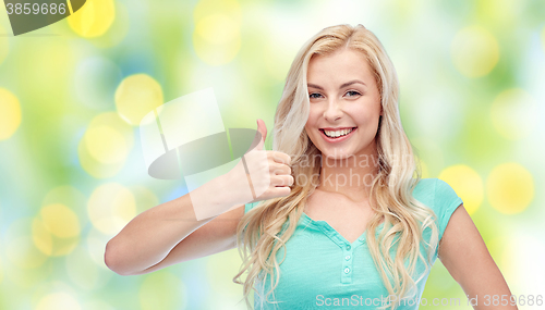 Image of happy woman or teenage girl showing thumbs up