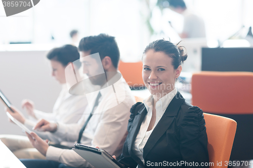 Image of business woman on meeting  using tablet