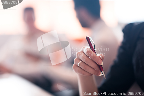 Image of woman hands holding pen on business meeting