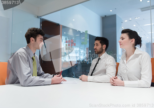 Image of young couple signing contract documents on partners back