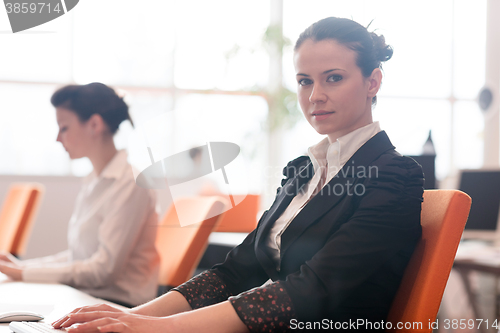 Image of business woman at  office people group in background