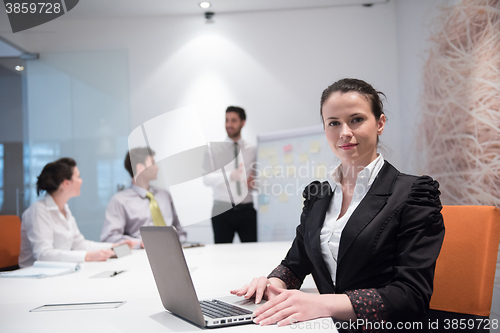 Image of young business woman on meeting  using laptop computer