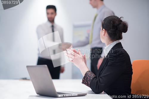 Image of young business woman on meeting  using laptop computer