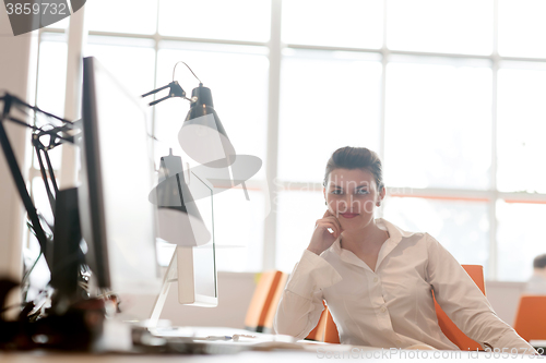 Image of business woman working on computer at office