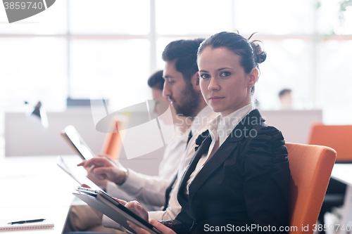 Image of business woman on meeting  using tablet