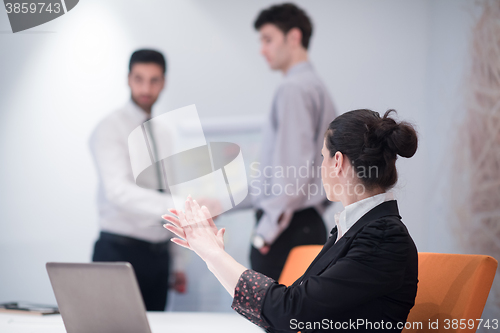 Image of young business woman on meeting  using laptop computer