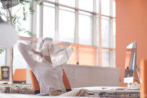 Image of happy young business woman relaxing and geting insiration