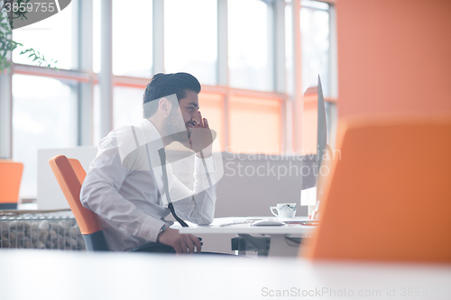 Image of young business man  working on desktop computer