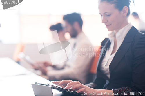 Image of business woman on meeting  using tablet