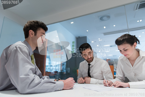 Image of young couple signing contract documents on partners back