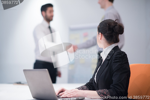 Image of young business woman on meeting  using laptop computer