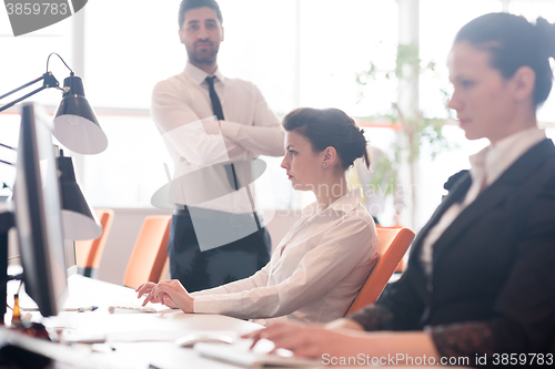 Image of business woman at  office people group in background