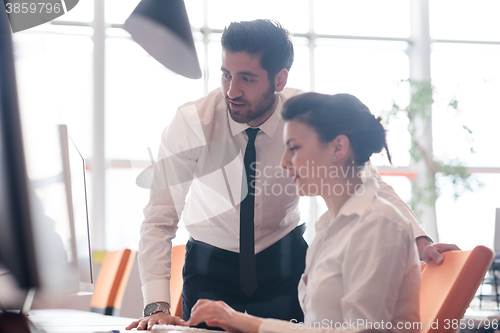 Image of business couple working together on project