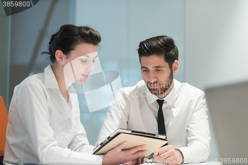 Image of young business couple working together on project