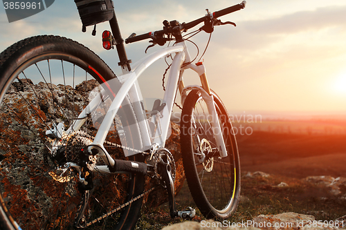 Image of Bicycle stands on a rock