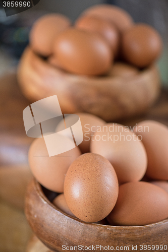 Image of Fresh eggs at wooden plate 
