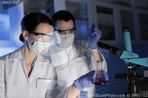 Image of close up of scientists making test in lab