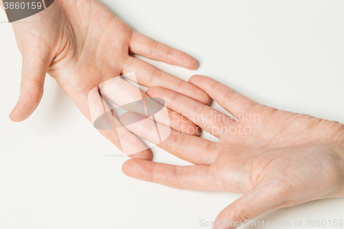 Image of close up of two hands connecting fingers together