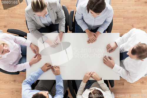 Image of close up of business team sitting at table