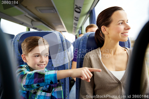 Image of happy family riding in travel bus