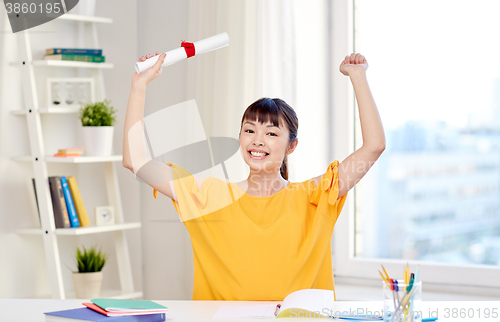 Image of happy asian woman student with diploma at home