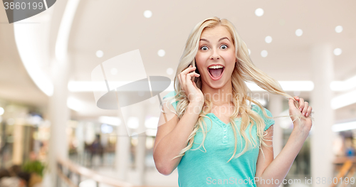 Image of smiling young woman calling on smartphone