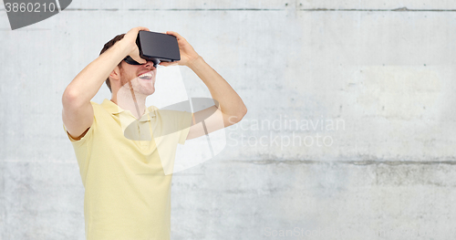 Image of happy man in virtual reality headset or 3d glasses