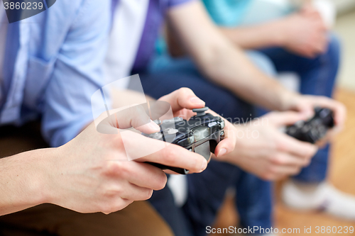 Image of close up of friends playing video games at home