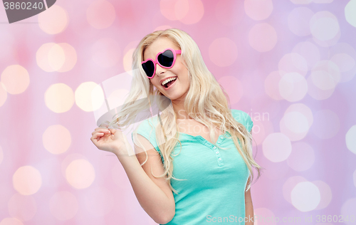 Image of happy young blonde woman or teenager in sunglasses