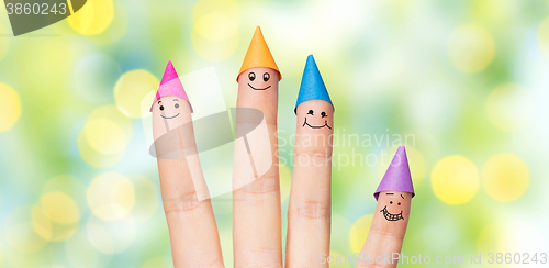 Image of close up of hand with four fingers in party hats