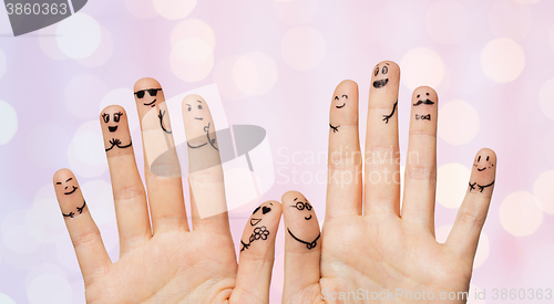 Image of close up of hands and fingers with smiley faces