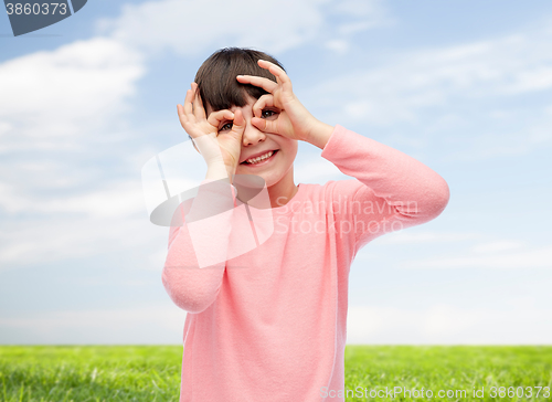 Image of happy little girl making faces and having fun