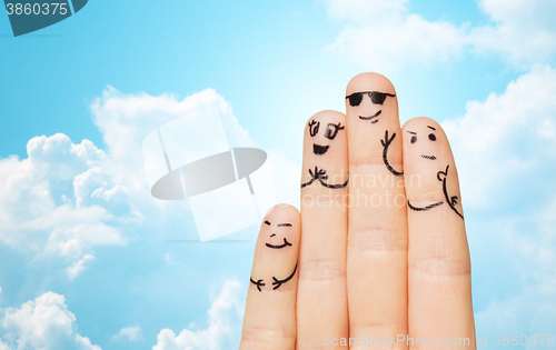 Image of close up of four fingers family with smiley faces