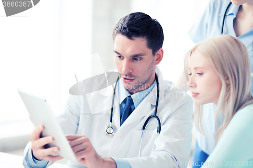 Image of doctor and nurse with patient in hospital