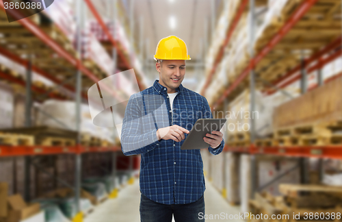 Image of happy businessman with tablet pc at warehouse