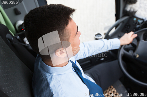 Image of close up of driver driving passenger bus