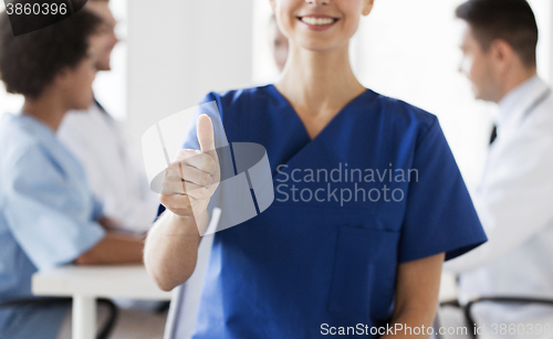 Image of close up of doctor showing thumbs at hospital
