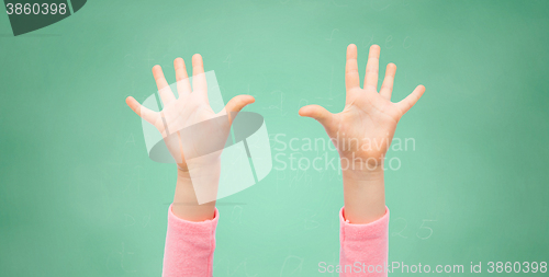 Image of close up of little child hands raised upwards