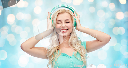 Image of happy young woman or teenage girl with headphones