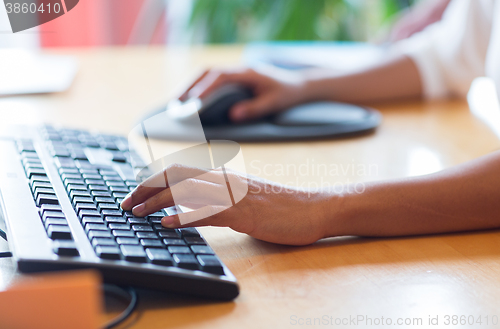 Image of close up of female hands with keyboard and mouse