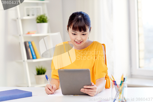 Image of asian woman student with tablet pc at home