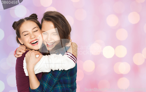 Image of happy smiling pretty teenage girls hugging