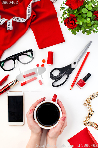 Image of The female hands with a cup of coffee and smart phone 