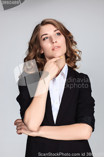 Image of The happy thoughtful woman on gray background