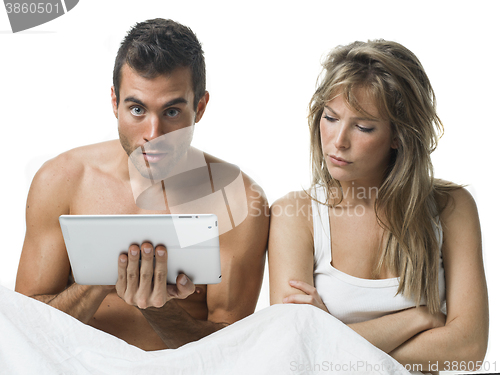 Image of uncommunicative couple on bed in white 